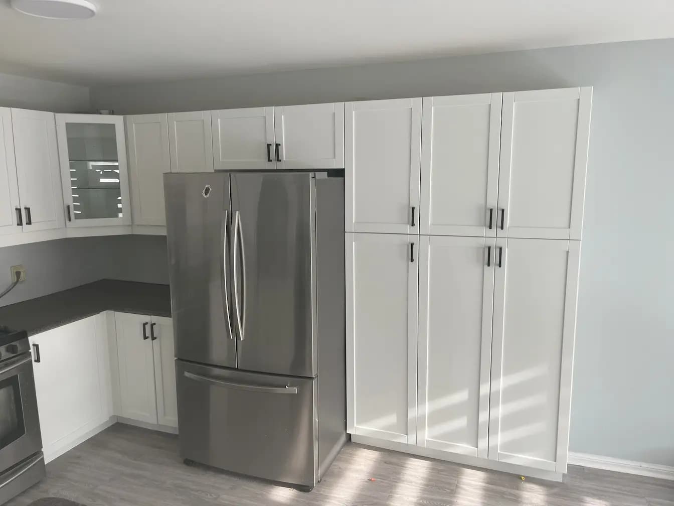 Kitchen with refinished white cabinets